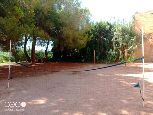 a basketball court with a net in a park at Casa Rural COMPLEX MASIA DEL TREMENDO y Agroturismo in Camarles