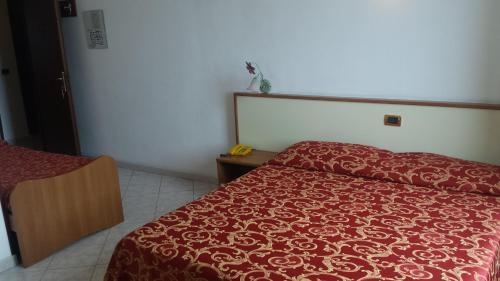 Ένα ή περισσότερα κρεβάτια σε δωμάτιο στο Hotel Ideale