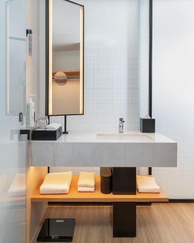 a bathroom with a sink and a mirror at Fairfield by Marriott Yining in Yining