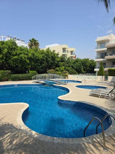 a swimming pool with blue water in a resort at Regina by the Sea in Limassol
