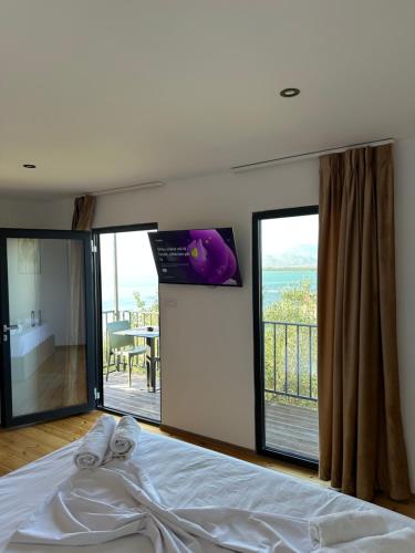a bedroom with a bed with a view of the ocean at Lake Escape Villa Shirokë in Shkodër