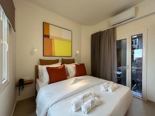 two beds in a hotel room with towels on them at A3 Tsimiski in Thessaloniki