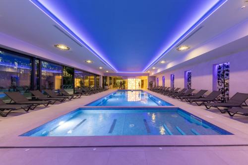 a swimming pool in a building with chairs at Mayak Resort in Kyiv