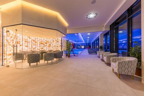a lobby with chairs and tables in a building at Mayak Resort in Kyiv