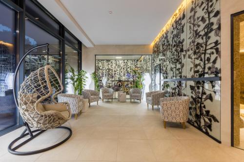a waiting room with a chair and tables at Mayak Resort in Kyiv