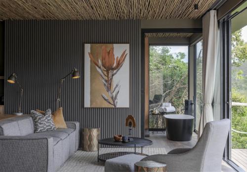 a living room with a couch and a table at Shamwari Bayethe in Paterson