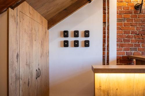 a room with a wooden door and a brick wall at Stara Przepompownia in Ostrów Wielkopolski