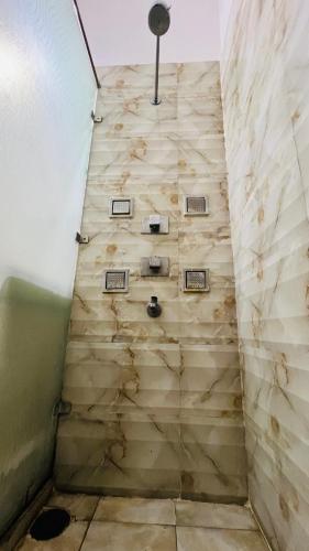 a bathroom with a wooden wall at The Lawn House : 3BHK Furnished Villa with Lawn in Amritsar