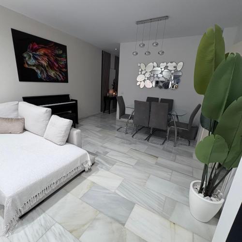 a living room with a bed and a dining room at Marbella urbanización privada in Marbella