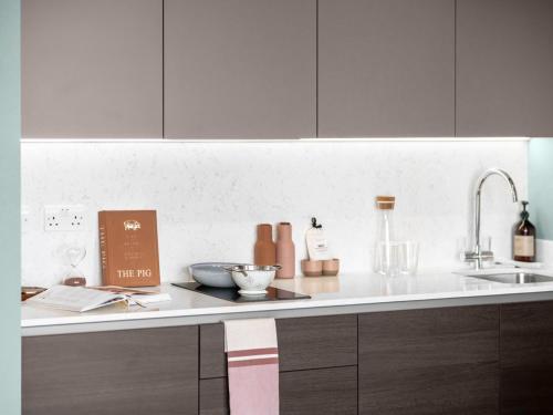 a kitchen with a counter top with a sink and a counter sidx sidx at Your Perfect Stay luxury Serviced Apartments- City Centre - Better and bigger than a hotel! in Birmingham