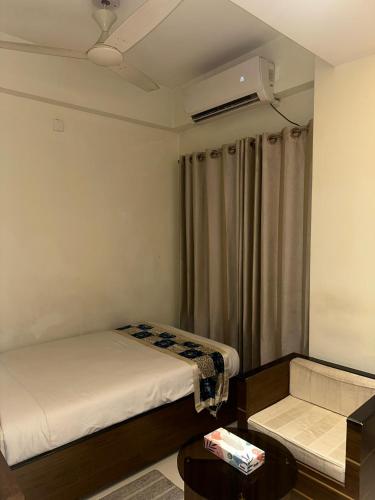 a small room with two beds and a air conditioner at Hotel The Grand Hyatt Dhaka in Dhaka