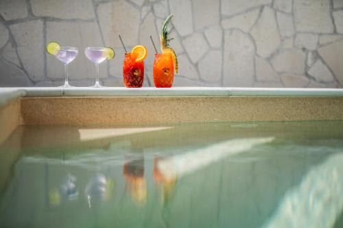 two glasses and two strawberries sitting on a ledge at Villa Aura - Pag Island in Jakišnica