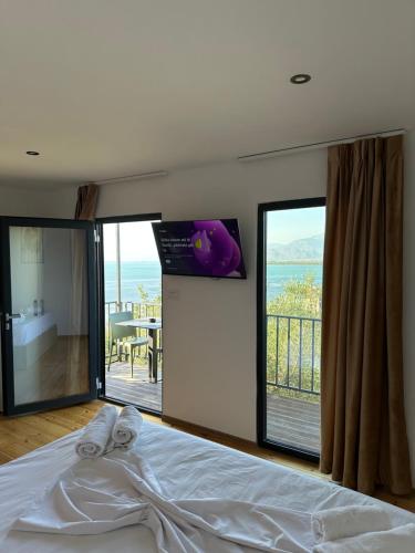 a bedroom with a bed with a view of the ocean at Lake Escape Villa Shirokë in Shkodër