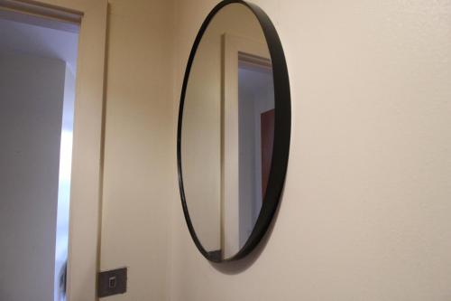 a mirror hanging on a wall in a room at Central Birmingham Apartment with Balcony & Netflix in Birmingham