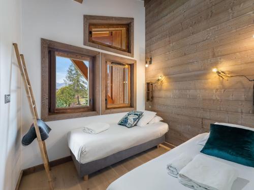 une chambre avec deux lits et une fenêtre dans l'établissement Appartement chaleureux à Megève avec sauna et parking - FR-1-569-55, à Megève