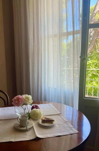 a table with a plate of food and a window at Villa Mariotti in Fano