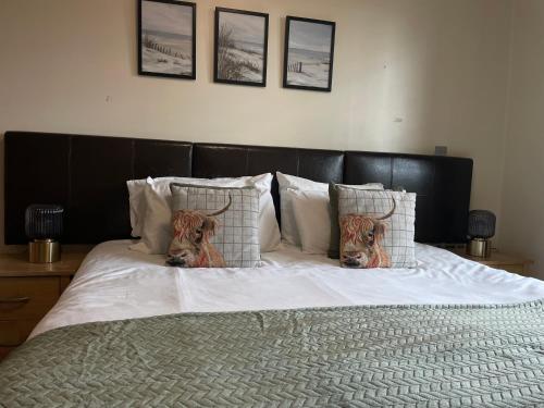 a bed with two deer heads on the pillows at Central Birmingham Apartment with Balcony & Netflix in Birmingham