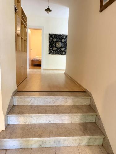 a staircase leading to a room with a painting on the wall at וילה נקודה בכנרת in Had Nes