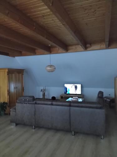 a living room with a couch and a blue wall at FW zur Gemütlichkeit in Hirschaid