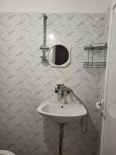 a bathroom with a sink and a mirror on the wall at Апартамент Стоянови in Primorsko