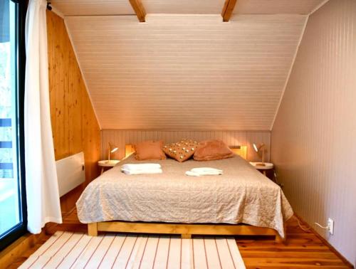 a bedroom with a bed with two towels on it at Daleko od Szosy in Krajęczyn