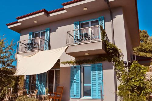 a villa with blue shutters on a building at Villa Luna in Marmaris