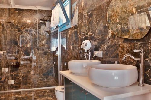 a bathroom with two sinks and a shower at Villa Luna in Marmaris