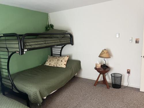 a bedroom with a bunk bed with a green wall at Uncas 16N - Spacious & Scenic Townhome in North Creek