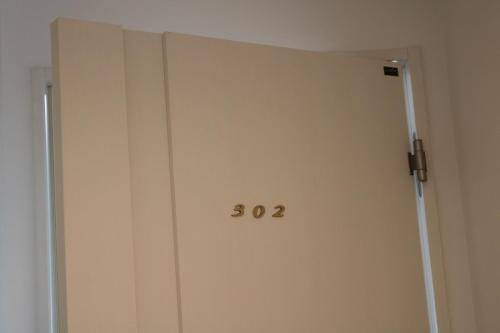 an open door with the number on it at Chiyoda-Home　Osu-sakae-Subways-JR trin-Spa-parking spot-WIFI in Nagoya
