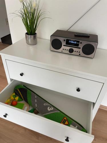 a white dresser with a radio and a plant at Brezovina Breza B115 in Veselé
