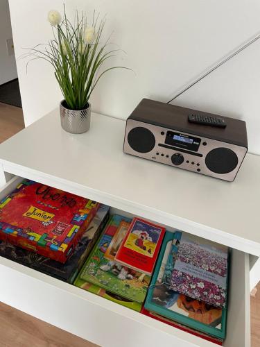 a white table with a radio on a shelf at Brezovina Breza B115 in Veselé