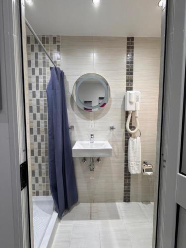 a bathroom with a sink and a mirror at Allegro Hotel in St Julian's