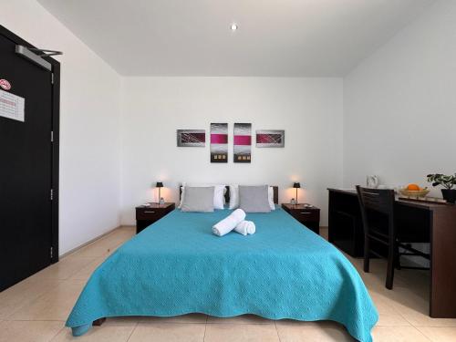 a bedroom with a bed with two towels on it at Allegro Hotel in St Julian's