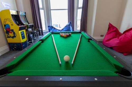 a pool table with cue balls in a play room at Entire Home on Beach Front, Sleeps 25 with Free Parking in Rhyl