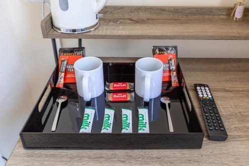 a black tray with chopsticks and remote controls on a counter at Entire Home on Beach Front, Sleeps 25 with Free Parking in Rhyl