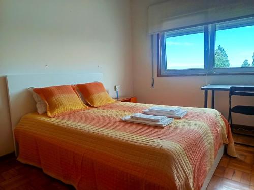 a bedroom with a bed with towels on it at Combatentes Apartment in Porto