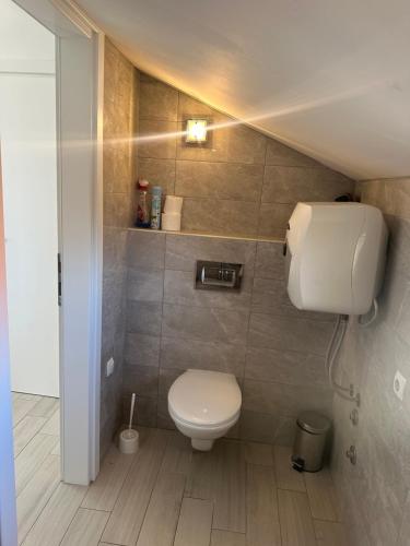 a small bathroom with a toilet in a room at Villa Dragic in Brodarica
