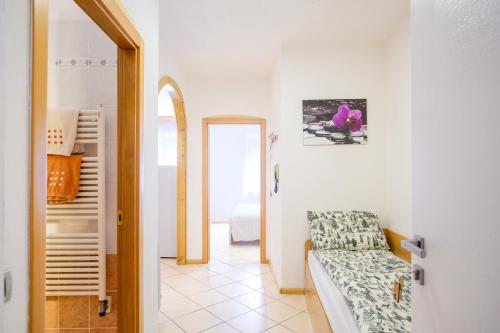 a corridor of a room with a bed and a doorway at Residenza Garibaldi in Molveno