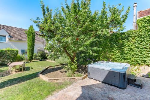 En have udenfor Appartement avec jardin - A 10 minutes de Disneyland