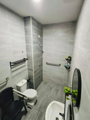 a bathroom with a toilet and a sink at Sapphire Garden Suites, SP Saujana in Sungai Petani
