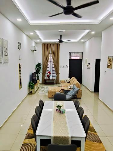 a living room with a couch and a table at Sapphire Garden Suites, SP Saujana in Sungai Petani