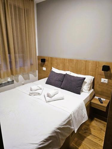 a bedroom with a large bed with two towels on it at Chilltorium Zlatibor in Zlatibor