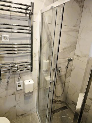 a bathroom with a shower with a glass door at Chilltorium Zlatibor in Zlatibor