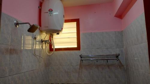 a shower in a bathroom with a window and a bench at Pears Tree Duplex Villa in Kodaikānāl