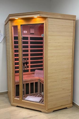 a wooden sauna with towels in a room at Kilian Suite in Miskolc