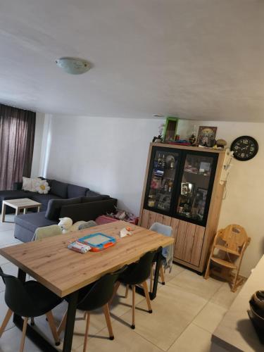 a living room with a wooden table and a couch at Tomorrowland rooms in Rumst