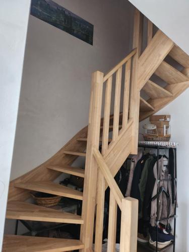 a stairwell with wooden risers and a ladder at Tomorrowland rooms in Rumst