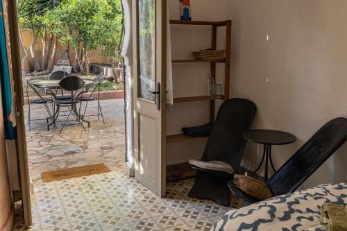 an open door to a room with chairs and a table at Dar Domingo in Chefchaouene
