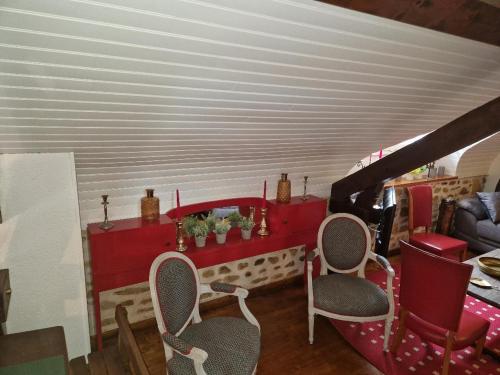 a living room with chairs and a red table at Domaine Garmidou in Lucq-de-Béarn