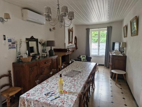 a dining room with a table with a wine bottle on it at Domaine Garmidou in Lucq-de-Béarn